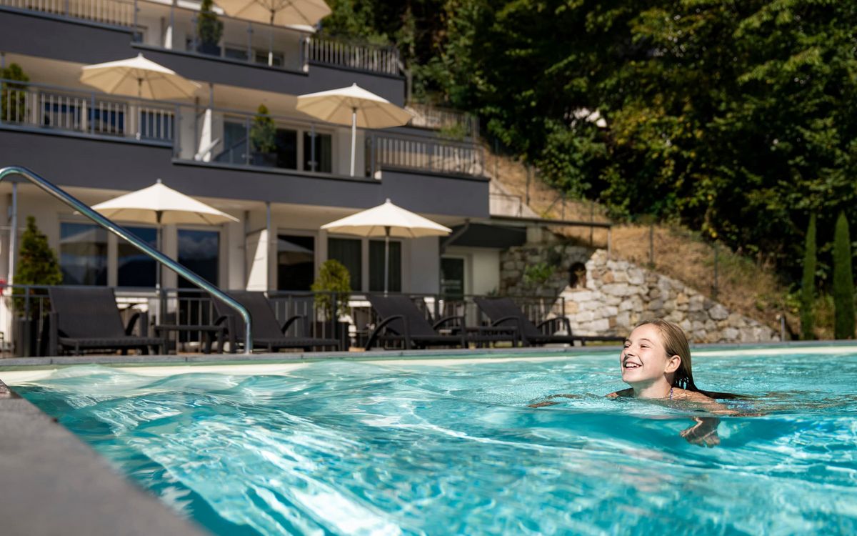 Dorf Tirol Holiday Residence Outdoor pool Sunbathing lawn Children Lechner